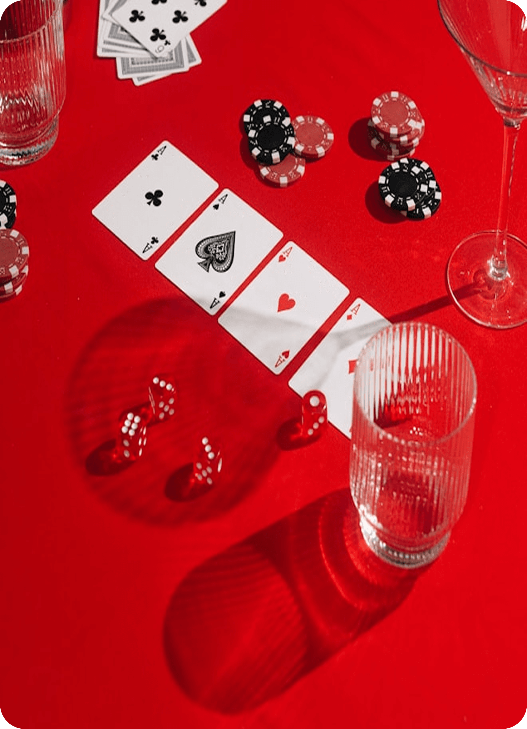 Traditional poker setup with cards and poker chips on a red table