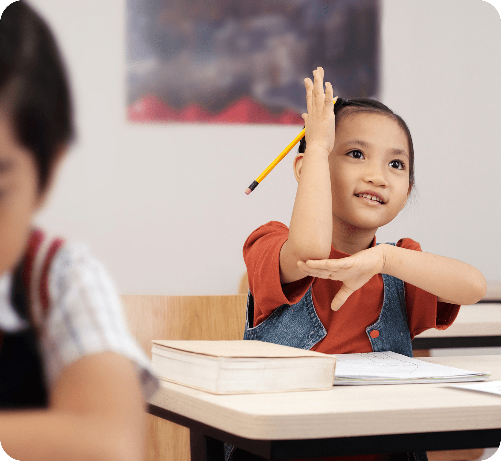 Student raising hand in classroom